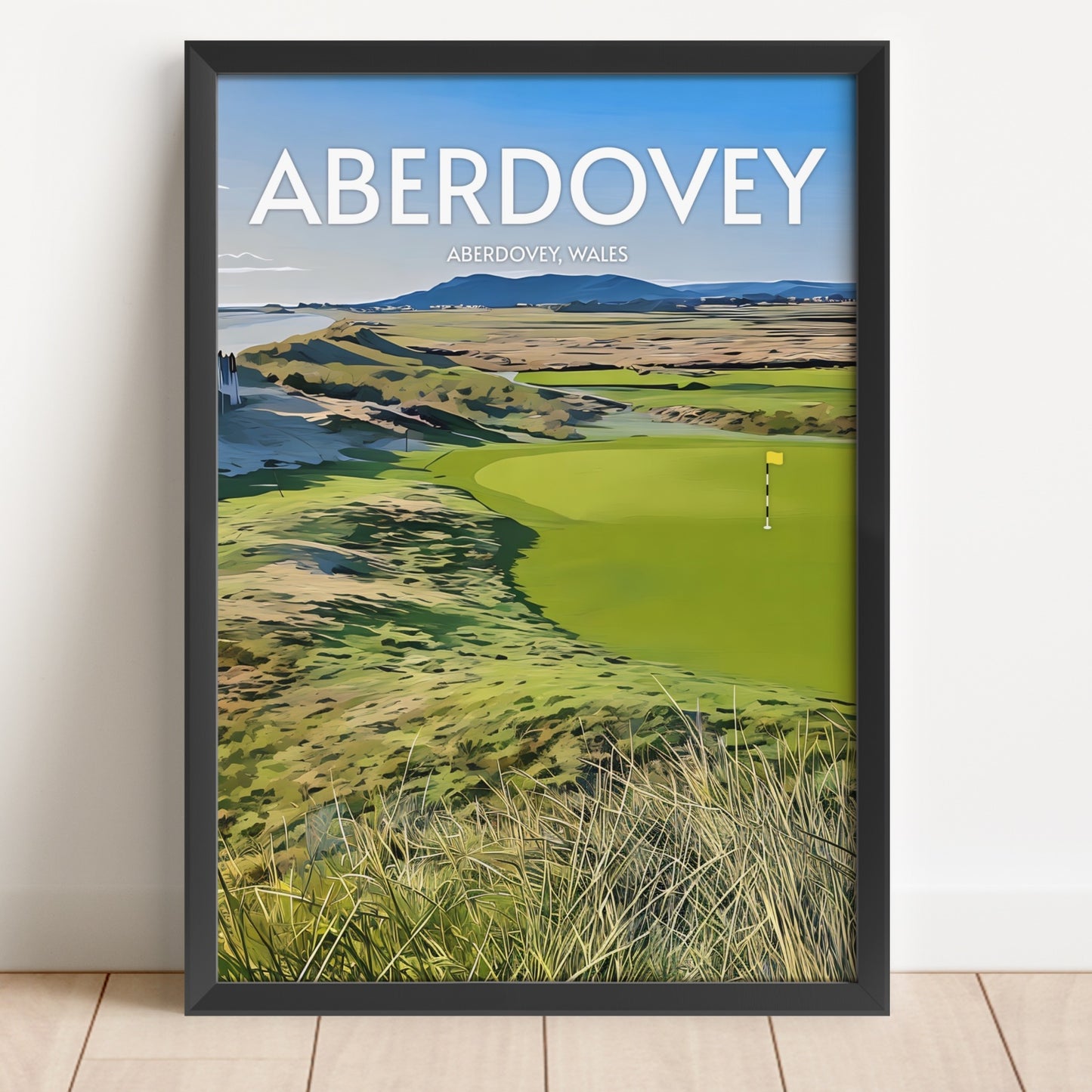 Framed poster of Aberdovey golf course with 'Aberdovey' text on a white wall.