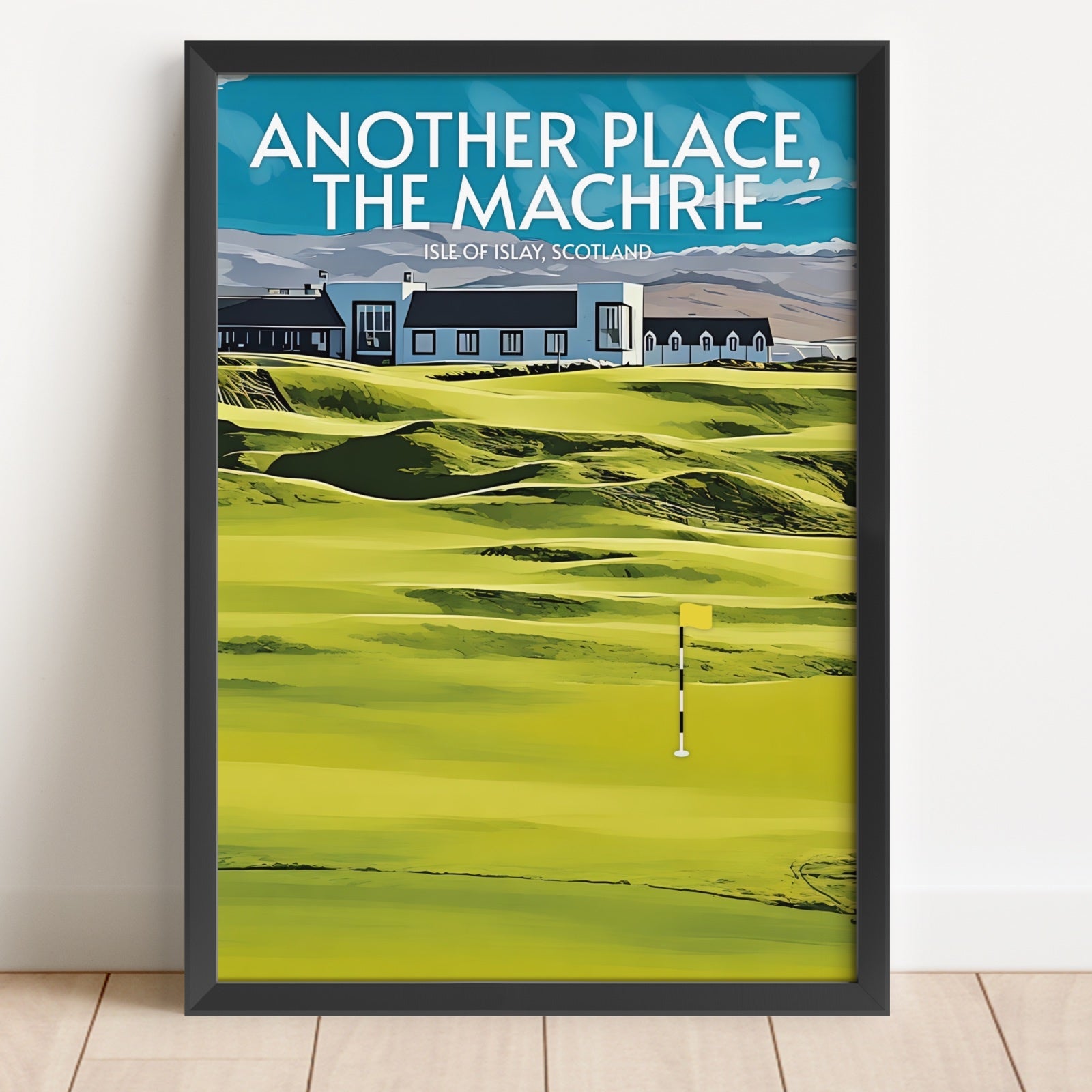 Framed poster of a golf course with text 'Another Place, The Machrie' on a white wall.