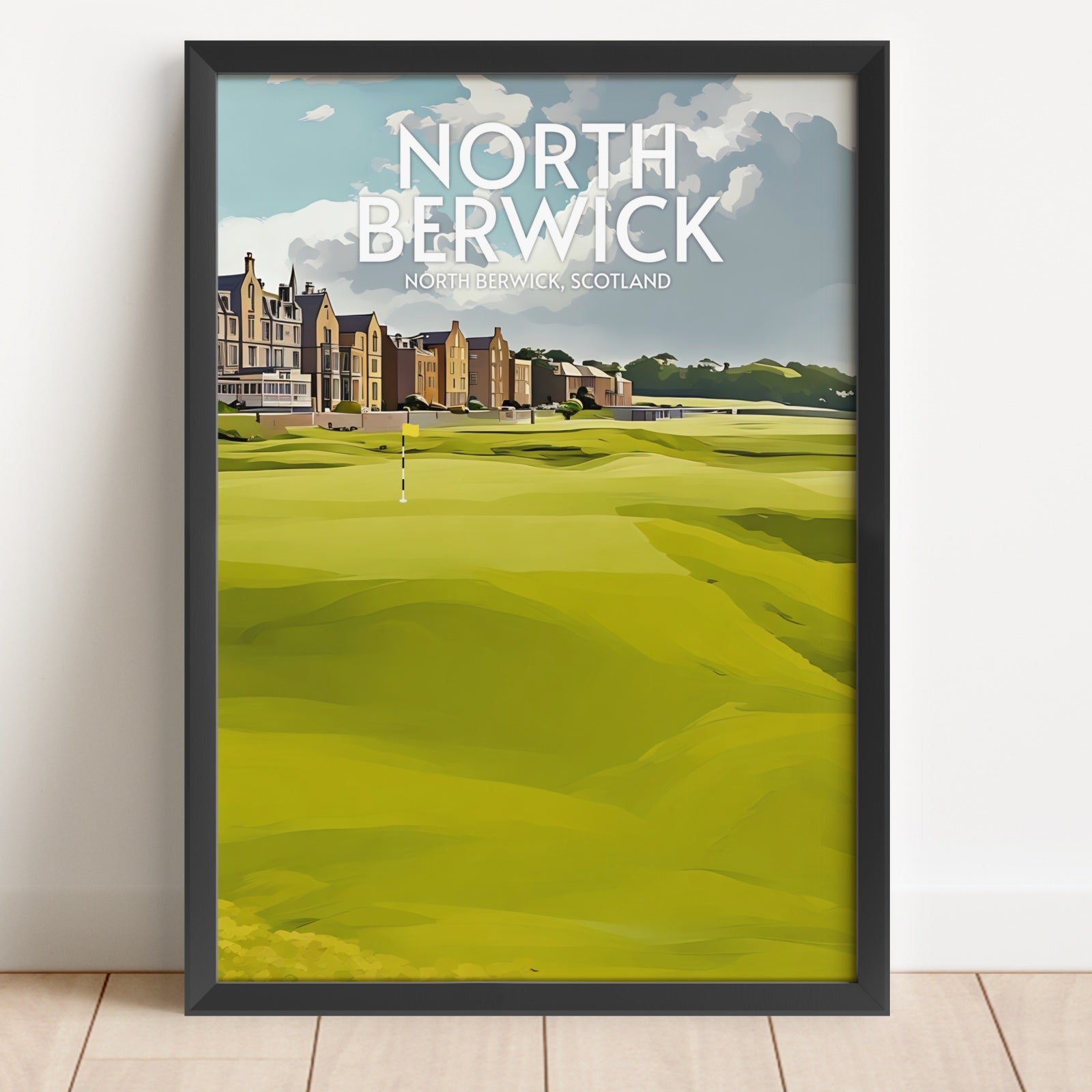 Framed poster of North Berwick golf course with a building in the background.