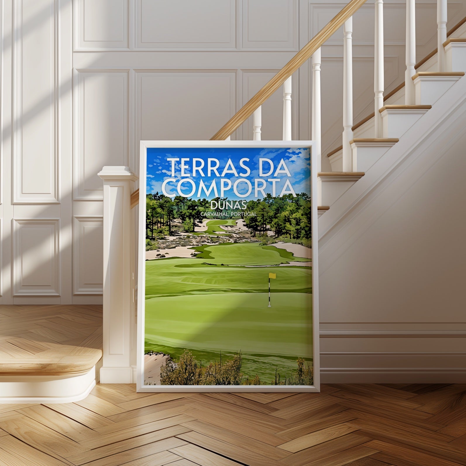 Framed poster of a golf course with 'Terras da Comporta' text in a room with wooden floor and staircase.