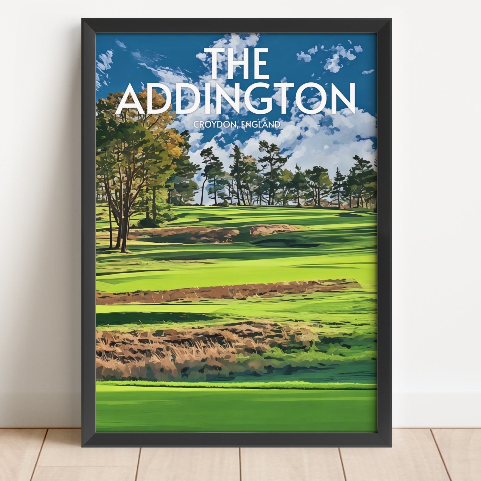 Framed poster of a golf course with 'The Addington' text on a white wall.