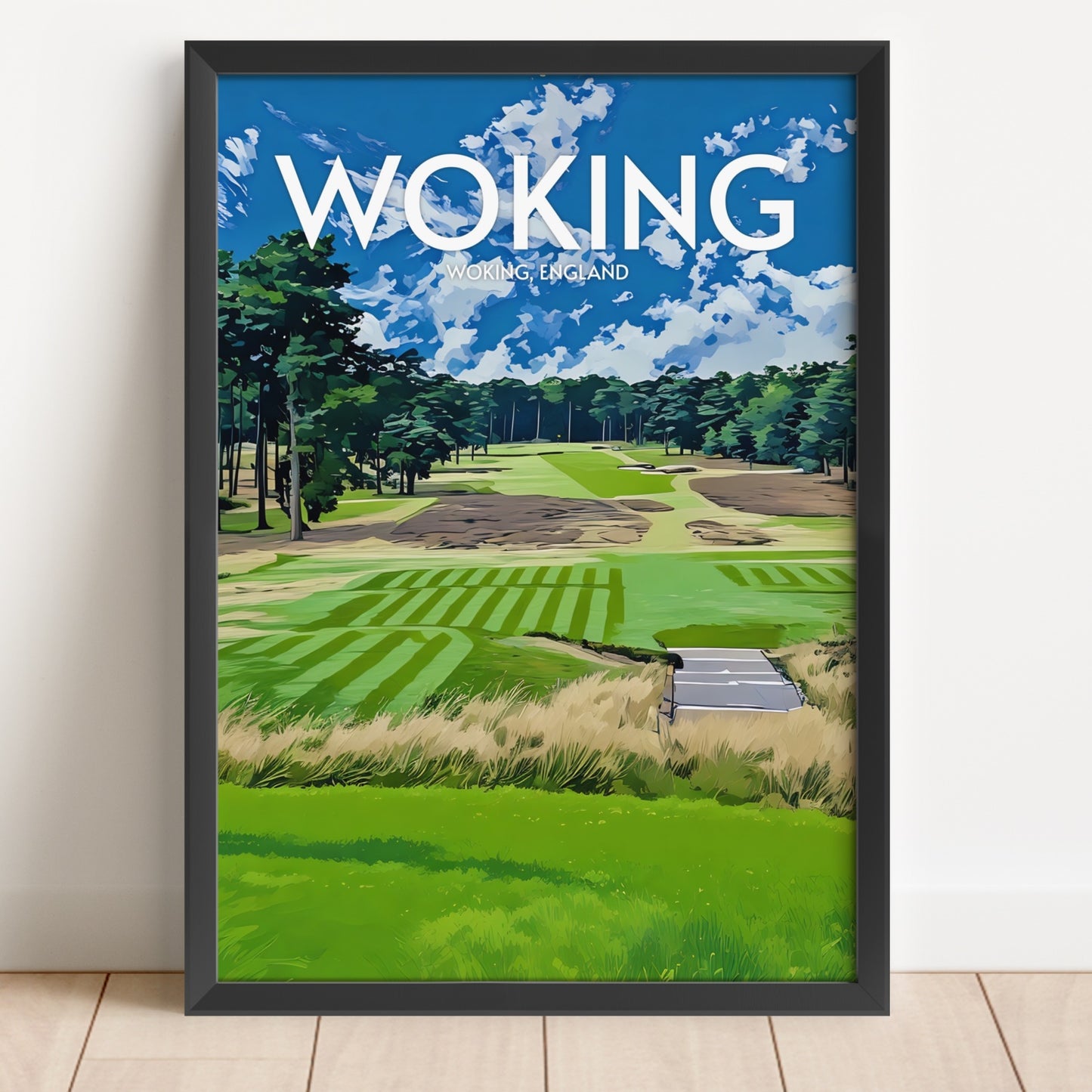 Framed artwork of a golf course with 'Woking' and 'Woking, England' text on a blue sky background.